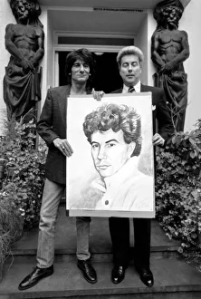 Rolling Stones: Ronnie Wood holds a painting of author Ken Follett who stands next to him