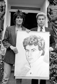 Rolling Stones: Ronnie Wood holds a painting of author Ken Follett who stands next to him