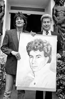 Rolling Stones: Ronnie Wood holds a painting of author Ken Follett who stands next to him