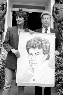 Rolling Stones: Ronnie Wood holds a painting of author Ken Follett who stands next to him