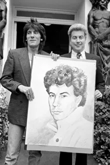 Rolling Stones: Ronnie Wood holds a painting of author Ken Follett who stands next to him