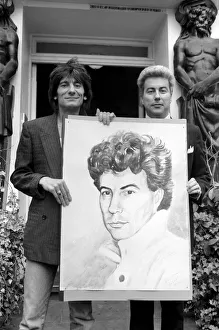 Rolling Stones: Ronnie Wood holds a painting of author Ken Follett who stands next to him