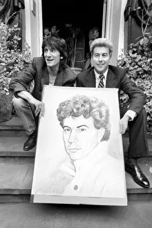 Rolling Stones: Ronnie Wood holds a painting of author Ken Follett who stands next to him