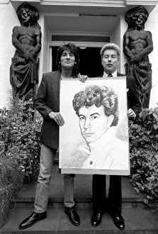 Rolling Stones: Ronnie Wood holds a painting of author Ken Follett who stands next to him
