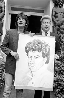 Rolling Stones: Ronnie Wood holds a painting of author Ken Follett who stands next to him