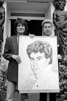 Rolling Stones: Ronnie Wood holds a painting of author Ken Follett who stands next to him