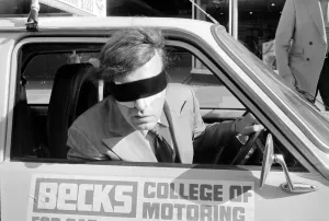 Romark - Hypnotist / Magician - 1977 taking driving lessons wearing a blindfold