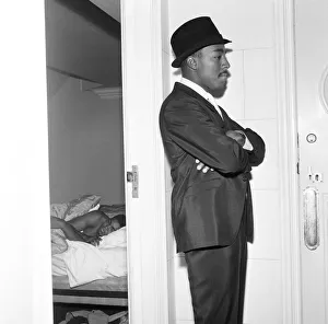Suit Prints: Ronald King Cassius Clay (Muhammad Ali) bodyguard keeps watch outside the Piccadilly