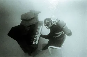 Ronnie Smith from Harrow Middlesex playing the piano underwater wearing a diving