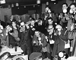 Cameras Prints: A room full of photographers take pictures of pop group The Beatles during their visit to