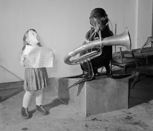 00192 Prints: Rosita Ruzza aged three considers that her ideal partner for singing christmas carols