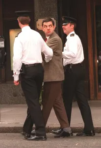 Rowan Atkinson Actor as Mr Bean filming at Harrods - being arrested by policemen