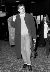 Rowan Atkinson departing from Heathrow Airport with mystery girl believed to be called