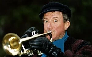 Images Dated 30th December 1992: Roy Castle TV Presenter and Entertainer plays a trumpet to celebrate his OBE honours in
