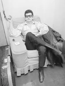 Roy Orbison, the American singer, relaxes in his dressing room before going on stage