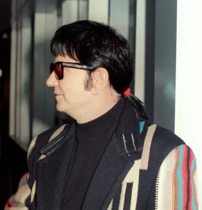 Roy Orbison at Heathrow Airport November 1988 in multi coloured coat