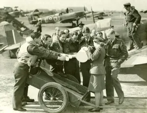 Serving Prints: Royal Air Force fighter pilots hold out their mugs whilst a Waaf girl pours them some tea