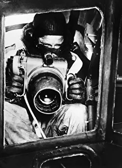 A Royal Air Force observer with the oblique camera used in reconnaissance work in WW2