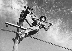 Forces Prints: Royal Corps of Signals. (Picture) A line man jointing wire on a permeant line