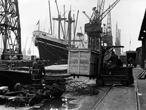 Royal Docks London January 1969 A driver with a fork lift truck moves a wooden