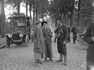 Royal Marine of the Naval Brigade seen here talking to two women ambulance drivers
