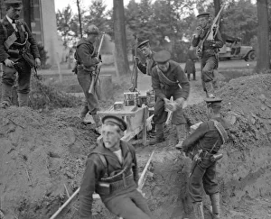 Royal Marines handing out tins of Bully Beef at the earthwork defences