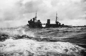 Royal Navy Battleship HMS King George V crosses the rough seas of the Atlantic Ocean