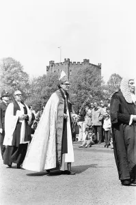The Rt Revd Dr John Habgood the Bishop of Durham strikes the doors of the Cathedral with