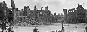 Ruined buildings and wrecked German transport in the streets of Montebourg as a result of
