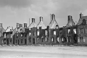 Ruined buildings and wrecked German transport in the streets of Montebourg as a result of