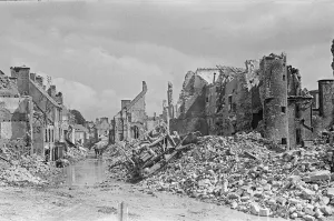 Ruined buildings and wrecked German transport in the streets of Montebourg as a result of