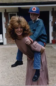 00133 Prints: Rula Lenska British Actress Founder trustee of Angels International carrying her nephew