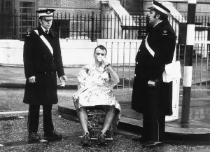 00187 Prints: Runner in the London Marathon March 1981 being helped by members of the St