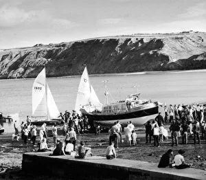 Accidents Prints: Runswicks new lifeboat, the Royal Thames is hauled up the beach watched by a large