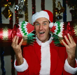 Russ Abbot comedian December 1986 dressed at Santa Claus holding Christmas cracker