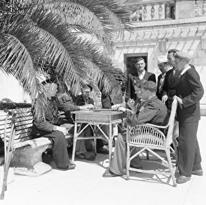 00082 Prints: Russian holiday makers seen playing domimoes under the shade of a palm tree