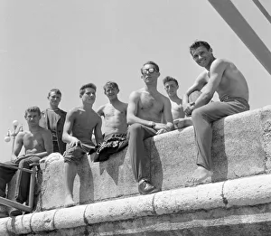 Russia Prints: Russian holiday makers seen sun bathing on the sea wall at Sochi in the region of