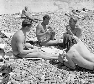 00082 Prints: Russin holiday makers seen here playing cards on the beach at Sochi region of Krasnodar