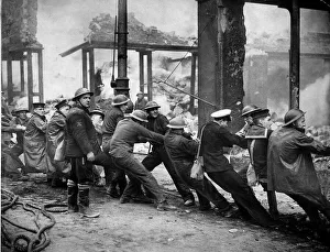 Sailors on leave in Glasgow help rescue workers pull wreckage from bombed building after