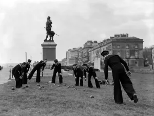 Sailors playing bowls on Plymouth Hoe under the watchful eye of Sir Francis Drake