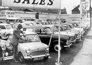Sales Prints: Salesman at P. P Motors, Richmond, puts a new price tag on a used Mini