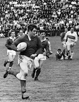 Running Prints: Salford rugby league player Jim Mills in action as he breaks away with the ball during