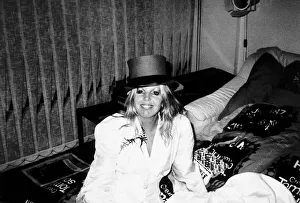 Sally Thomsett Actress in white suit wearing a top hat sitting