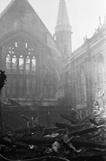 Salvage workers pick through the burnt out remains of London