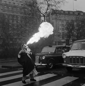 Road Prints: Sammy Kamel, a young Egyptian fire eater stops traffic in London. 23rd April 1970