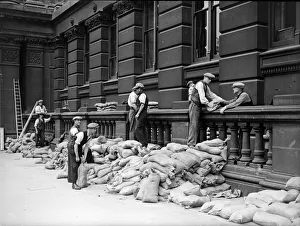 Outbreak Prints: Sandbags being placed against the walls of the Birmingham Education Committee building in