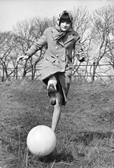 Sandie Shaw, singer, pictured kicking a ball March 1965