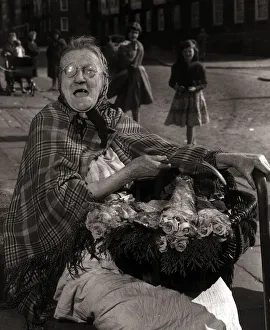 Seller Prints: Sarah Burke aged 78 Flower Seller - February 1961 sells flowers on the streets of