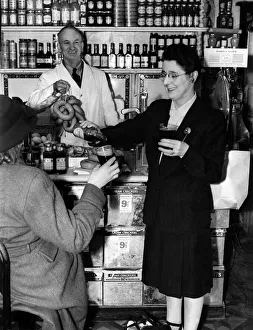 Groceries Prints: Sausages and Stout While shop assistant Carl Skinner brings out sausages for