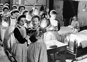 Scene at Westminister Hospital on Christmas Eve - 1940 Nurses walk through wards